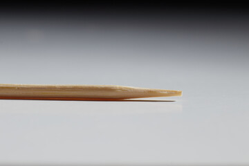 wooden toothpick stick lying on the table macro photo blurred background