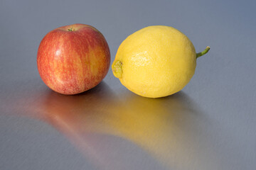 tenderness between tasty red apple and yellow lemon