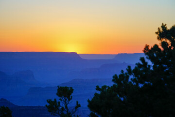 Golden Sunset at Grand Canyon Arizona. Blue smoky haze accentuates the canyon.