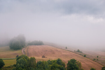 Morning fog over country hills. Summer landscape.
