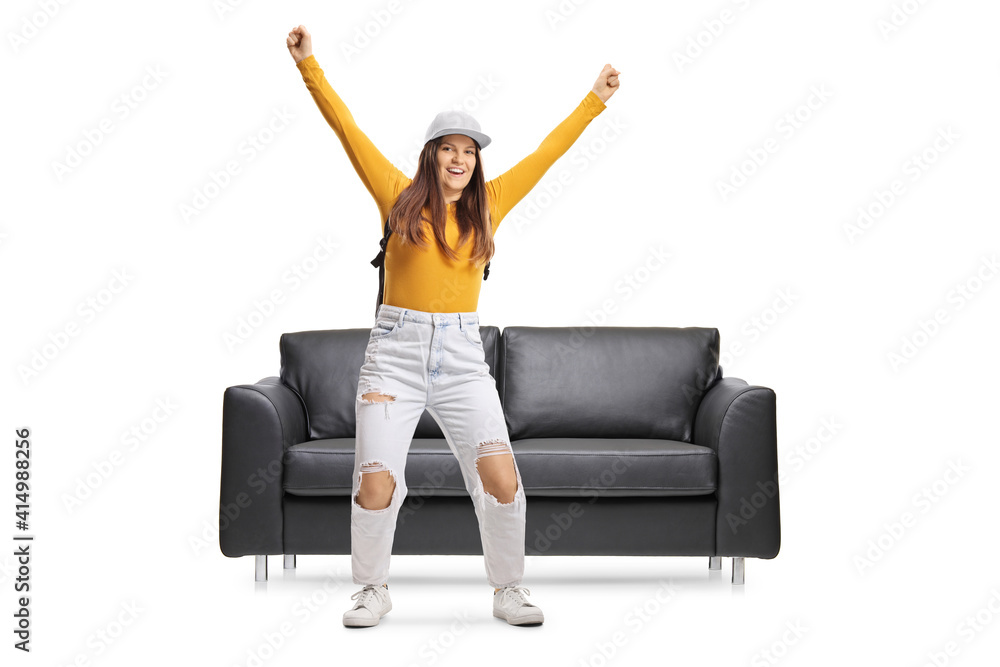 Canvas Prints Full length portrait of a happy young female jumping froma sofa