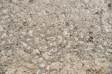 The texture of the old stucco on a brick wall.