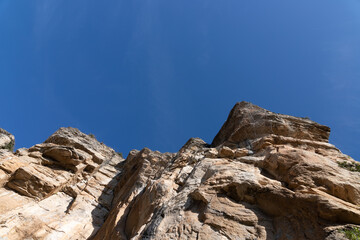 Steep cliff with Protection wire mesh against falling rocks from the mountains