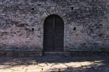 Fototapeta na wymiar Old medieval door of abandoned house, interesting old vintage design of a front door