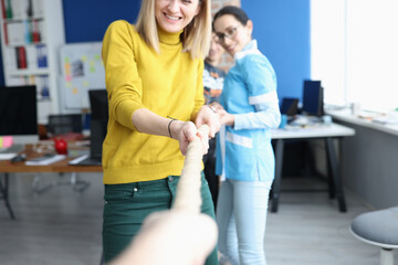 Group of people pulling rope in office closeup