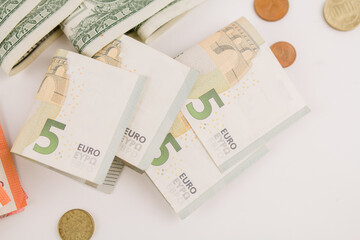 euro paper money with coins on a white background