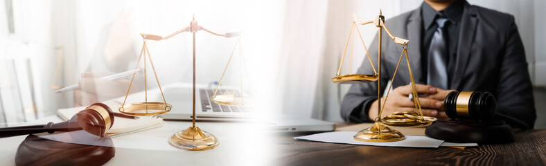 Justice and law concept.Male judge in a courtroom with the gavel, working with, computer and...
