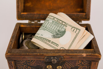 a paper money dollars in a wooden chest