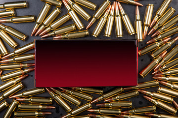 Background from rifle cartridges on a gray metal back. A box of cartridges.  Copy space for text in...
