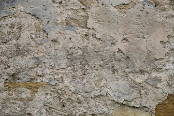 The texture of the old stucco on a brick wall.