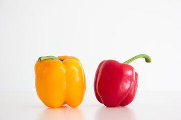 Red and Yellow ripe Bell peppers close up studio shot isolated on white