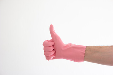 Pink latex cleaning glove on Caucasian male hand making thumbs up gesture isolated on white background