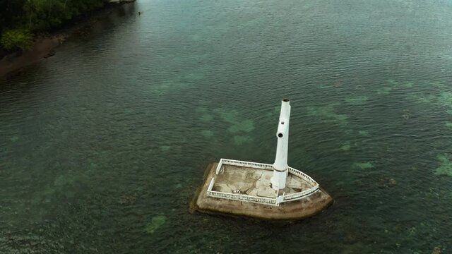 Catholic cross in sunken cemetery in the sea at sunset, aerial view. Sunset at Sunken Cemetery Camiguin Island Philippines.