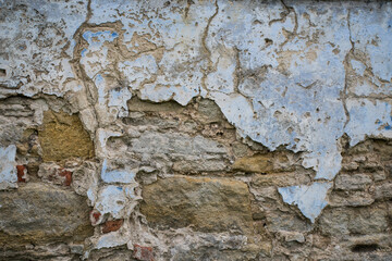 The texture of the old stucco on a brick wall.