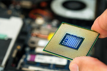 Man hand holding CPU, processor close-up for PC computer and notebook, separate CPU macro image ,...
