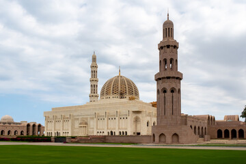 Sultan Qaboos Grand Mosque in Muscat, Oman, landscape view, with majestic marble walls and minaret.