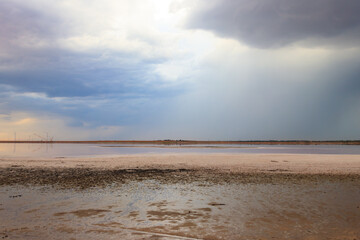 Dark storm clouds over a salt lake before a rain