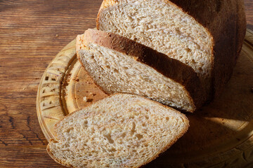Fresh homemade wholemeal brown bread on a breadboard