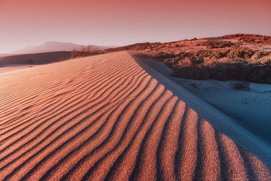 Atmospheric And Mystical Moody Light Of The Sunset Sunbeam Illuminated The Slope Of A Sand Dune Somewhere In The Depths Of The Sahara Desert