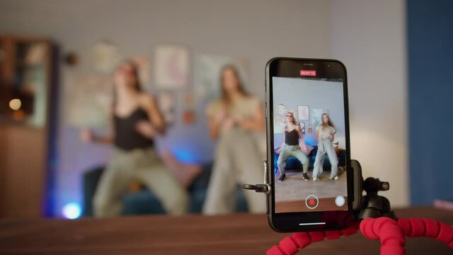 Teenagers womans shooting together dancing at home when making video for social media, stories hip hop popular trandy dance, students at home make content