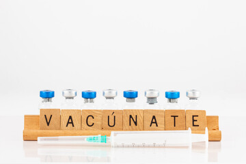 Get vaccinated concept in white background. Get vaccinated in spanish: vacúnate