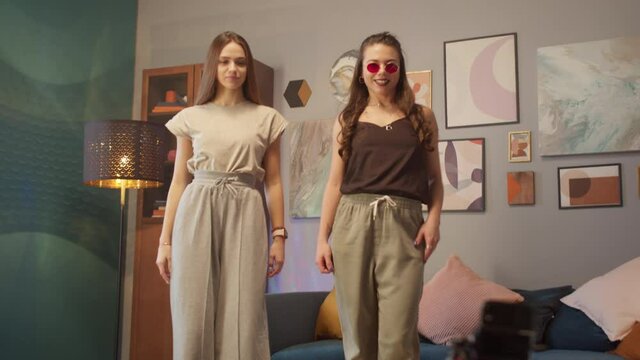 Teenagers womans shooting together dancing at home when making video for social media, stories hip hop popular trandy dance, students at home make content