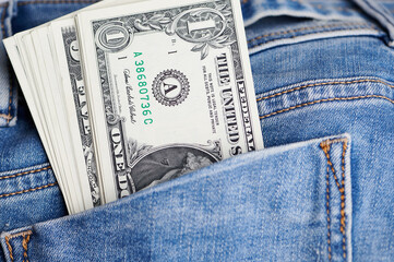 close up of dollar banknotes in a jeans pocket
