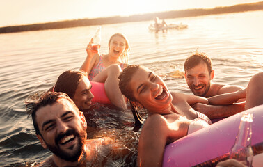 Friends enjoying a summer day swimming at the lake.