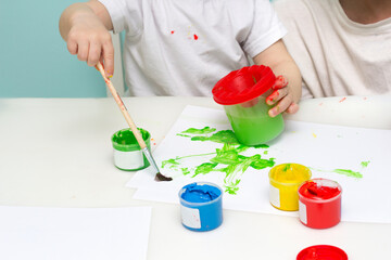 Painting for kids. Little boy paints his art work. Children development concept. Art school baby class.