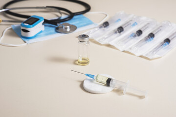 Vaccine readiness. Syringe with vaccine and necessary elements for diagnosis and vaccination