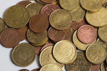 Coins scattered on the table. White background. Finance.