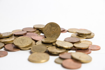 Coins scattered on the table. White background. Finance.