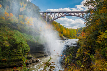 Fototapeta na wymiar waterfall in autumn with a bridge above the Genesee River , in Letchworth State Park, New York. 
