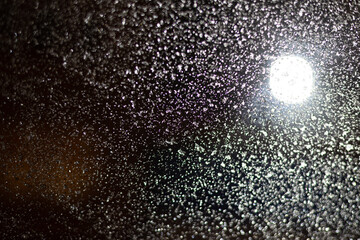 Blurred background with raindrops and lights.