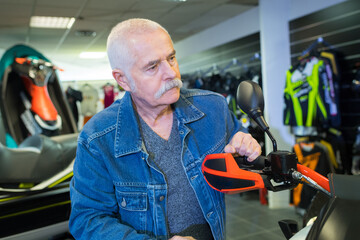 senior man in motorsport showroom