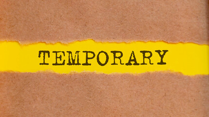 TEMPORARY written under torn paper on yellow background