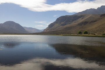 Tranquil mountain lake and reflex of sky on it