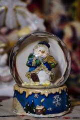 Figurine of a snowman in a glass sphere.