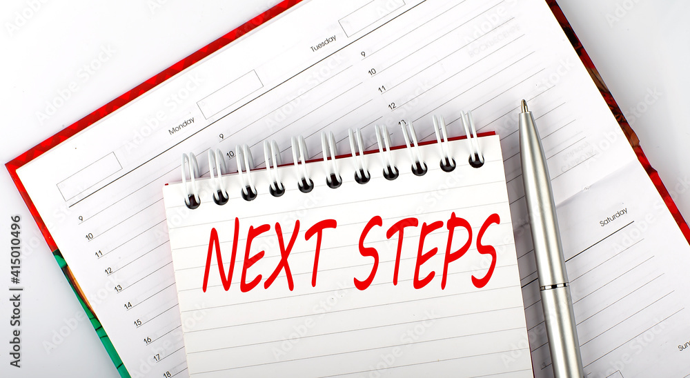 Poster next steps text on notebook on the diary,business