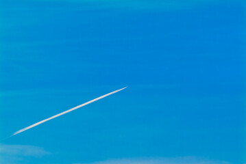a white trail in the sky from a flying plane
