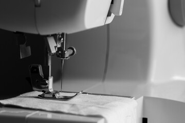 sewing machine in black and white mode, slow fashion and home sewing concept
