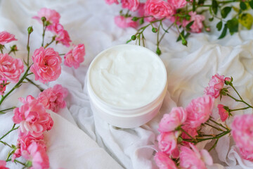Face and body cream with pink roses on white