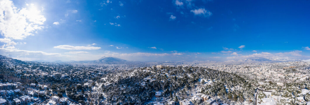 Athens Greece covered with snow panorama, sunny winter day, blue sky background