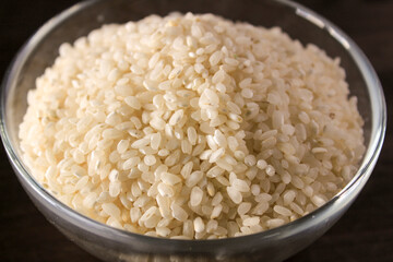 White rice texture and background in glass bowl