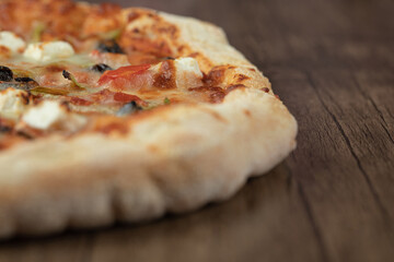 Cooked pizza dough with mixed chopped and minced ingredients