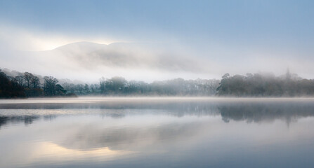 Fototapeta na wymiar Misty morning reflections on the lake 