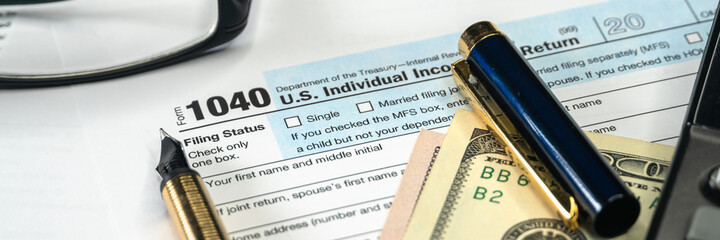 Tax form USA business income office concept. Tax Return Form 1040, wide banner