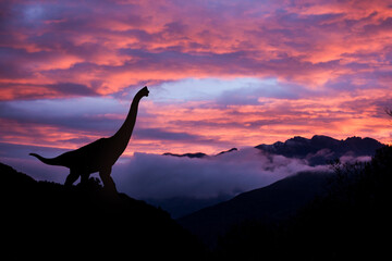 Silhouette of a brachiosauru at sunrise in the jurassic period. © fabio