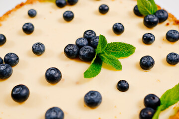 homemade cheesecake decorated with blueberry berries and mint leaves. Cooking desserts and cakes. Confectionery.