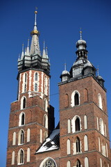 Fototapeta na wymiar Towers of Saint Marys church in Krakow, Poland, against blue sky